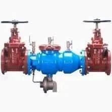 The 10 Zurn Wilkins OS & Y Grooved x Grooved Valve is essential for fire protection systems, featuring a white-mounted assembly with two red gate valves on each side and a central blue valve, along with additional components for flow regulation.