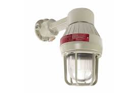 This industrial-style outdoor light fixture features a protective metal cage around a glass bulb and is part of Potter Electric Signals fire protection system. It mounts on a short, angled arm with a round base in light gray, marked with the red EXP PRF Strobe label.
