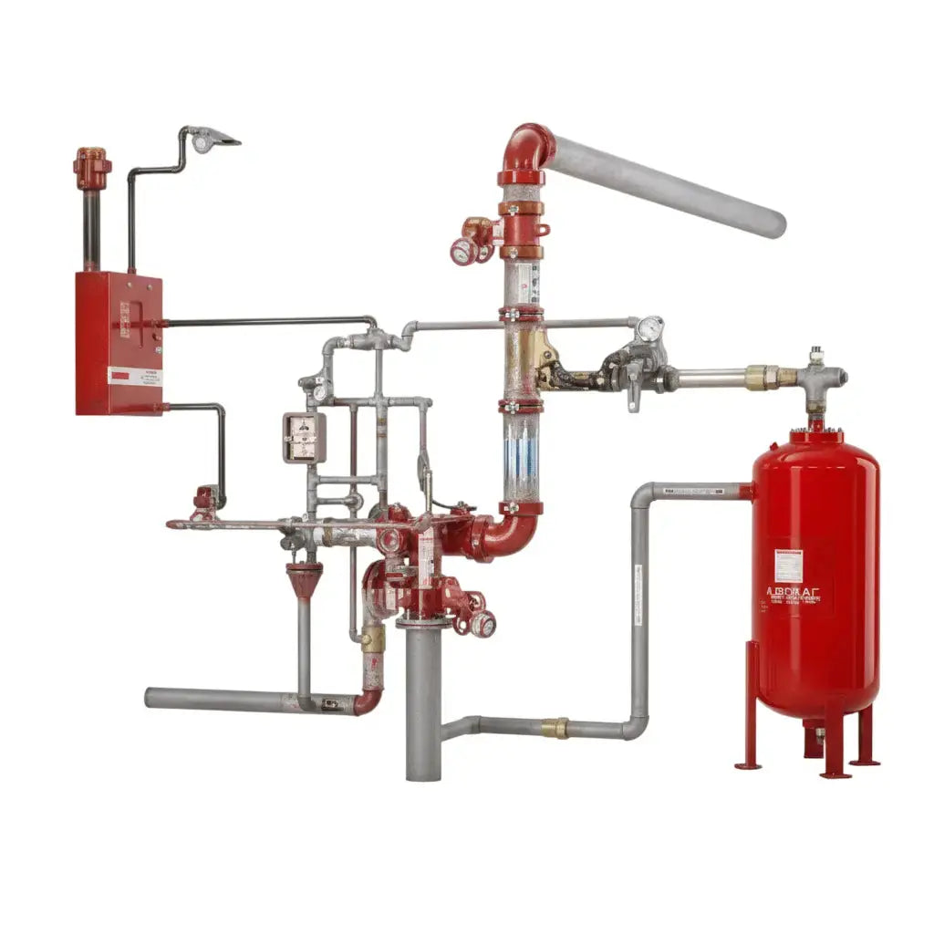 Red foam fire suppression system with pipes, valves, and a pressure tank in an industrial setting